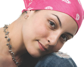Photo of a woman wearing a pink head-scarf.